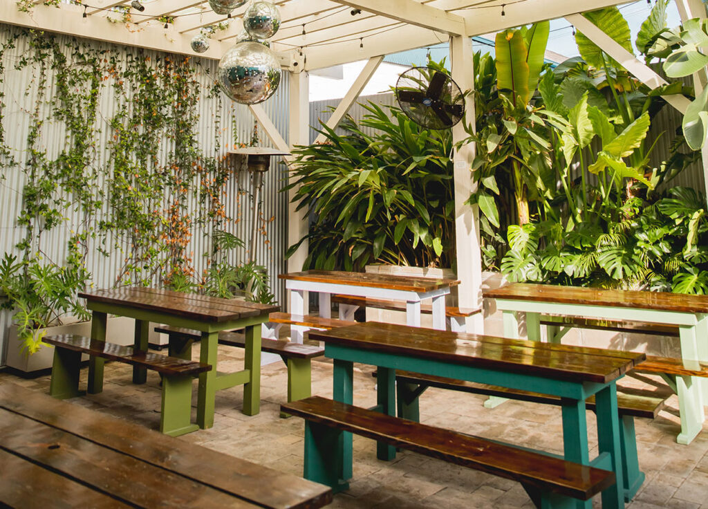 Long, patio-style tables at Miel Brewery's beer garden