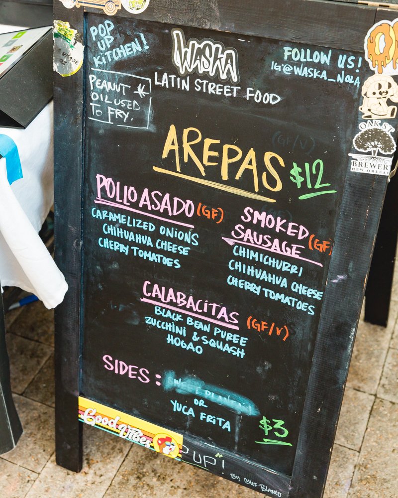 Waska Latin Street Food menu, including pollo asado, arepas, and smoked sausage