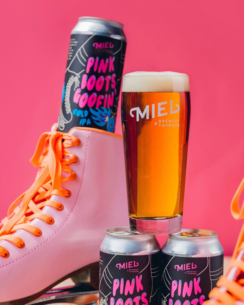 pinks boots goofin 16 oz can in skate next to pink